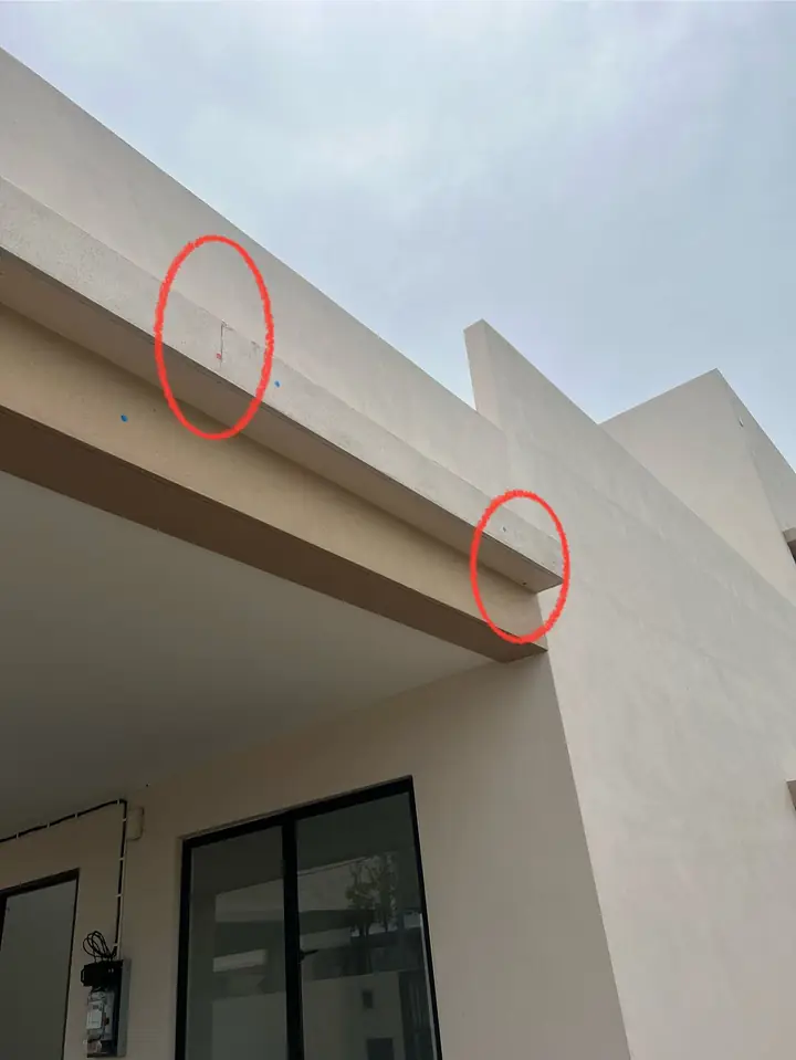 Cracks on a car porch beam, circled in red