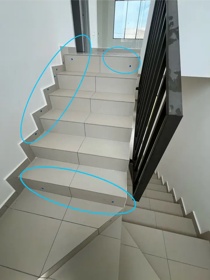 Staircase with hollow step tiles and skirting circled in blue